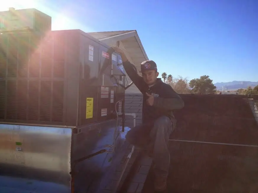 HVAC technician performing HVAC Inspection on a rooftop unit in West Caln